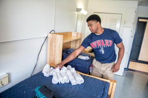 Student with folded laundry